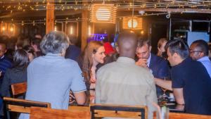 een groep mensen die aan een bar zitten bij Inside Afrika Boutique Hotel in Kigali