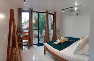 a dog laying on a bed in a room at Corong Beach Resort in El Nido