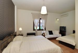 A bed or beds in a room at Enalion Hotel