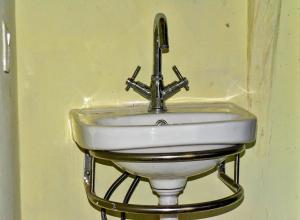 a sink in a bathroom with a faucet at Bardiya Eco Safari Homestay in Bhurkīā