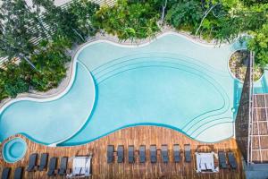 uma imagem de uma piscina num resort em Ophelia Tulum em Tulum