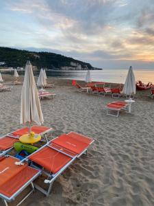 a group of lounge chairs and umbrellas on a beach at Iris Gargano Vacanza in Peschici