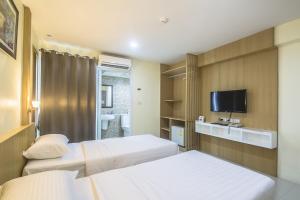Postel nebo postele na pokoji v ubytování Petchsiri Boutique Hotel เพชรสิริ บูทิค + 37 fotografií