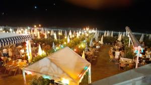 a group of tables and chairs with lights at night at NICE EXCEPTIONNEL 2 PIECES DANS APPARTEMENT D HOTE 40 M2 ATYPIQUE ORIGINAL 200 m mer PROMENADE DES ANGLAIS, PLAGES in Nice