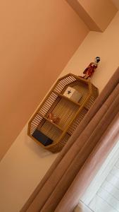 a bird cage on the wall of a room at Mon ti Kaz Mon ti Bonheur in Saint-André