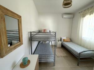 a room with two bunk beds and a mirror at CASA OLEA a San Pietro in Bevagna - Casa Vacanze in Puglia - Ferienhaus in Apulien - summer cottage in Apulia in San Pietro in Bevagna