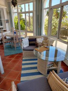 a living room with a glass table and chairs at Villa Carmen in Torrox Costa