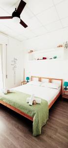 a large bed in a room with a ceiling fan at U'Cuntu affittacamere in Favignana