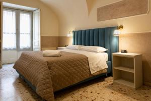 A bed or beds in a room at Il Gattopardo House