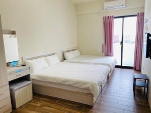 Postel nebo postele na pokoji v ubytování Penghu Happy House