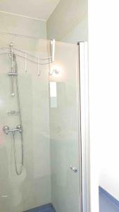 a shower with a glass door in a bathroom at Logement au calme et en plein cœur ! in Neufchâteau