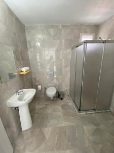 a bathroom with a toilet and a sink and a shower at Bavella Boutique Hotel in Pamukkale