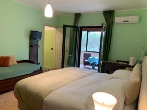 a bedroom with a bed and a window with a table at Tenuta Monaci La Murra in Carmiano