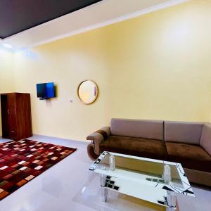 a living room with a couch and a table at Pelataran Seroja Villas in Wonosobo