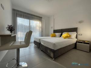 a bedroom with a bed and a chair and a window at Magic Kefalonia Villa in Spartia +103 photos