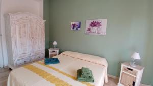 a bedroom with a bed with two night stands and two tables at S'Orgosa in Orgosolo