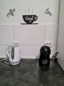 a kitchen counter with a coffee maker and a toaster at Apartman Vinyl - self chek-in in Osijek