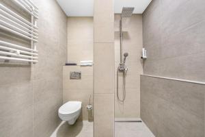 a bathroom with a toilet and a shower at Hotel Roudna in Plzeň