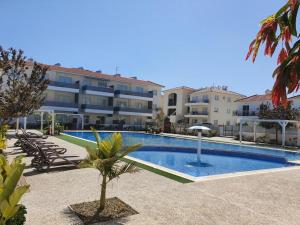 a swimming pool in front of a large building at Mythical Sands AM10 in Paralimni