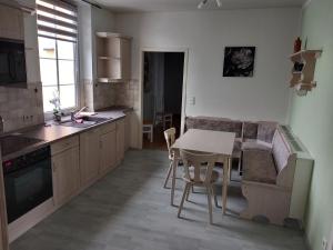 a kitchen with a table and a couch and a table at Hotel Eintracht in Mittweida +38 photos