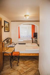 a small room with a bed and a desk at Chata Korenný vrch Pezinská Baba in Pezinok