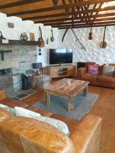 a living room with a couch and a coffee table at St Patrick's Cottage 