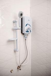 a bathroom with a blow dryer on the wall at Senita Bed & breakfast in Kigali