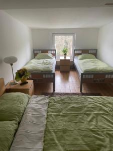 a bedroom with two beds and a window at My easy home in Hamburg