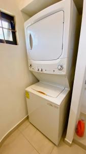 a white television sitting on top of a refrigerator at San Angel Villas in San Antonio