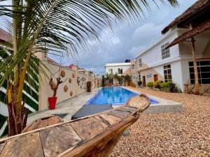 a wooden bench sitting next to a swimming pool at VICK Boutique Hotel with NEW power backup in Nungwi