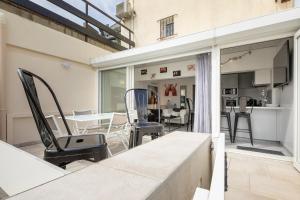 a balcony with a table and chairs in a room at VILLA PORT NATURE village naturiste in Cap d'Agde