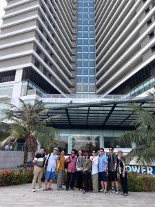 a group of people standing in front of a building at FLC Sea Tower Quy Nhon -Tran Apartment in Quy Nhon