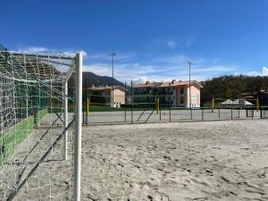 a soccer field with a goal in the sand at Bran & Denise Residence in Costermano sul Garda