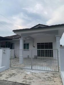 a white house with a gate in front of it at Homestay 69 in Hutan Melintang
