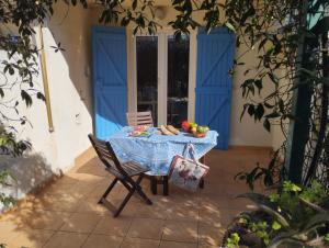 a table with a blue table cloth on a patio at Le Surplage in Hyères