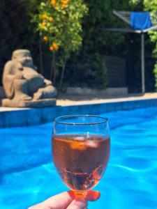 a person holding a wine glass in front of a pool at Casa Francesca Altea piscina y aparcamiento privado in Altea