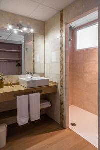 a bathroom with a sink and a shower at Hostal La Cigüeña in Portinatx