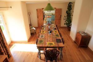 a long wooden table with chairs in a room at Fremington Hall Farm, Reeth, Swaledale in Reeth