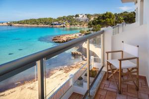 a balcony with a view of the beach and ocean at Hostal La Cigüeña in Portinatx