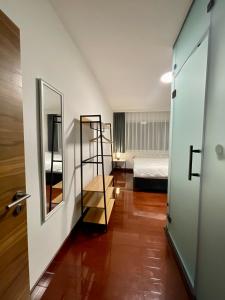 a hallway with a room with a bed and a mirror at SOHO Green Pristina Kosovo in Pristina
