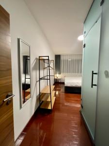 a hallway with a room with a bed and a mirror at SOHO Pristina Kosovo in Pristina