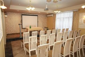 a conference room with chairs and a whiteboard at Fontush Boutique Hotel in Ivano-Frankivsk