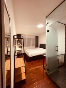 um pequeno quarto com uma cama e um espelho em SOHO Pristina Kosovo em Pristina