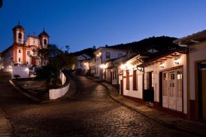 a cobblestone street in a town at night at Pousada Do Ouvidor in Ouro Preto