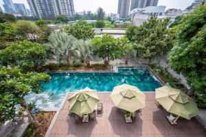 an overhead view of a swimming pool with umbrellas at Cozrum Homes - Sonata Residence in Ho Chi Minh City