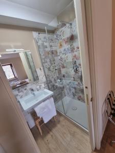 a bathroom with a shower and a sink at LucyBen GuestHouse in Cascia