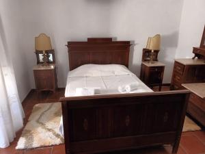 a bedroom with a bed and two night stands at Casa Morais Pinto in Reguengos de Monsaraz