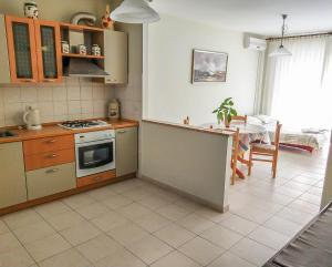 eine Küche mit einem Tisch und einem Herd Top-Backofen in der Unterkunft Keran 2+2 in Podgora