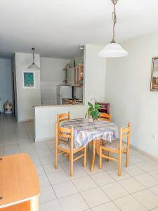 a kitchen and dining room with a table and chairs at Keran 2+2 in Podgora