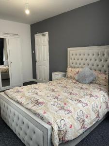 a bedroom with a bed with a comforter on it at The Botley Road House in Oxford